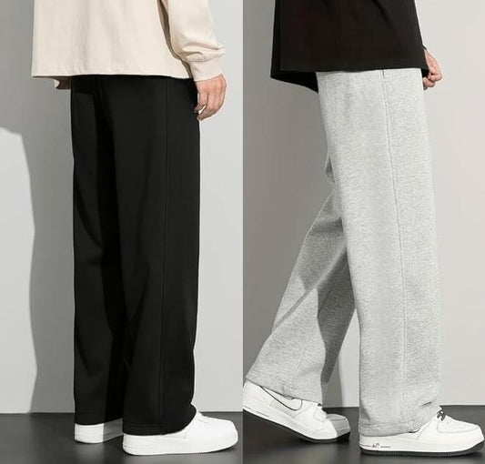 Two pairs of pants, one black and one gray, worn by models on a plain background.