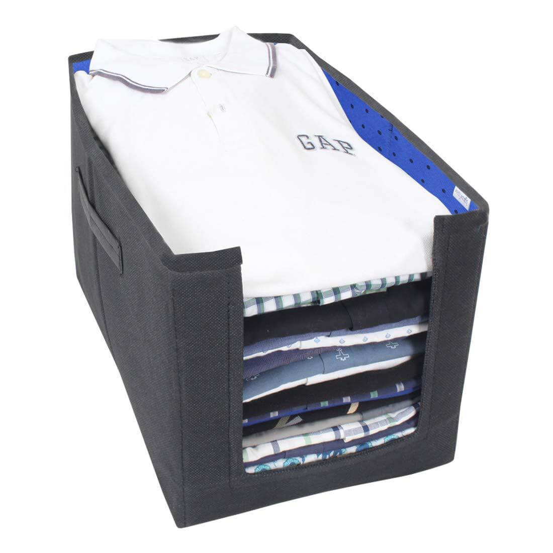 Black folding organizer with folded shirts including a Gap brand shirt on a white background