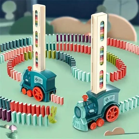 Toy train set with colorful dominoes on a green surface