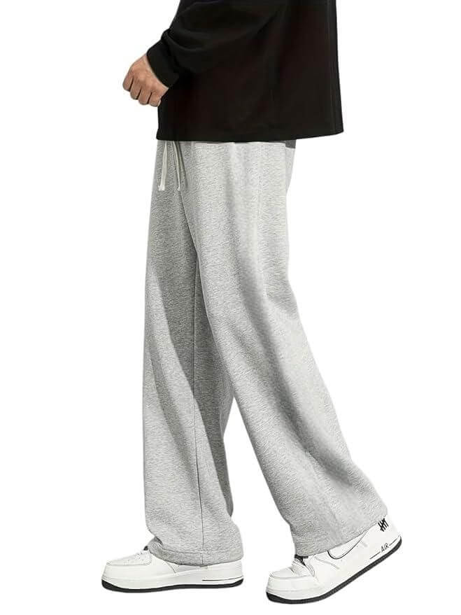 Gray sweatpants worn by a person on a white background
