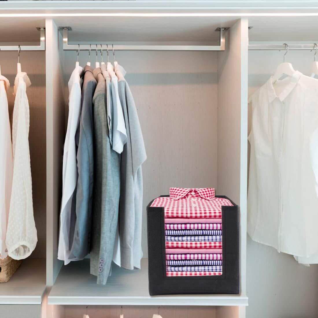 Closet with hanging clothes and a storage box with a patterned lid.