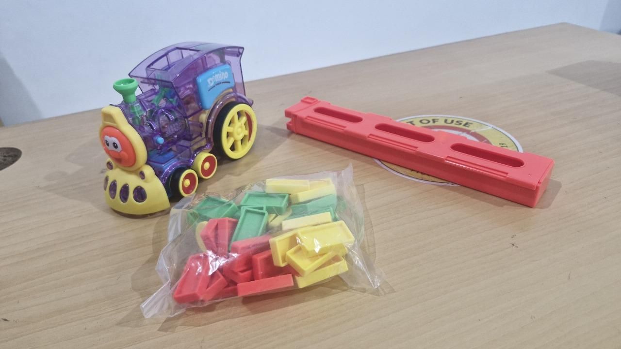 Toy train set with colorful plastic pieces on a wooden surface