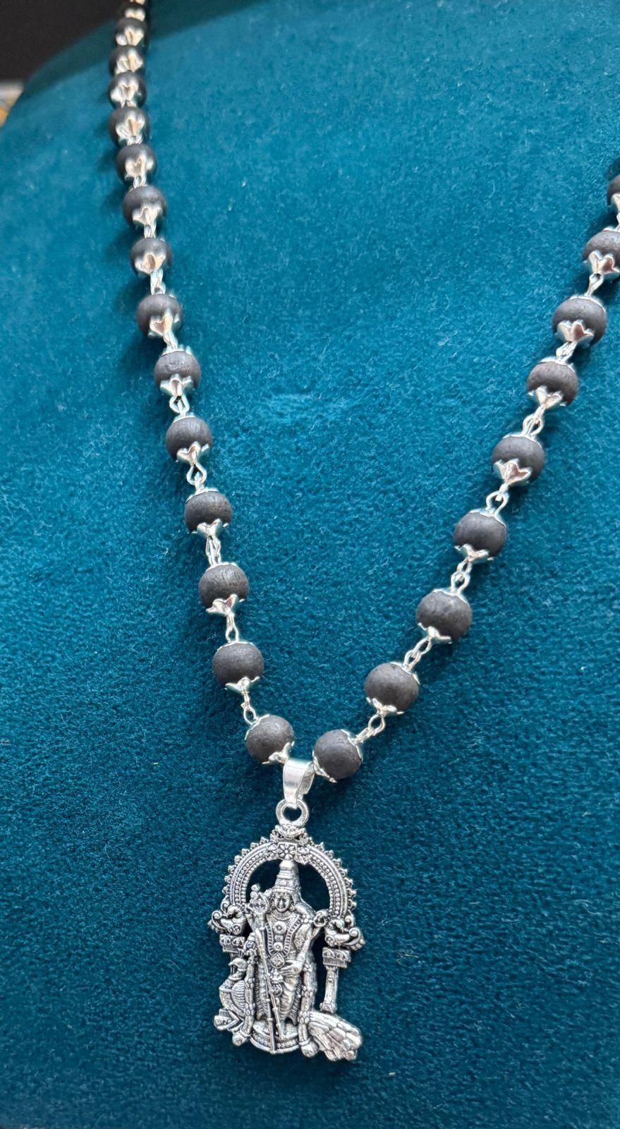 Karungali mala necklace with silver plated Murugan locket, featuring black wooden beads, ideal for casual and spiritual wear.