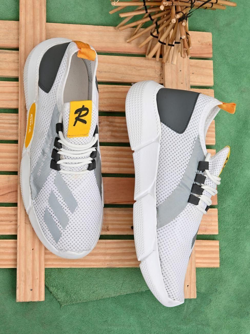 White sneakers with gray accents on a wooden surface