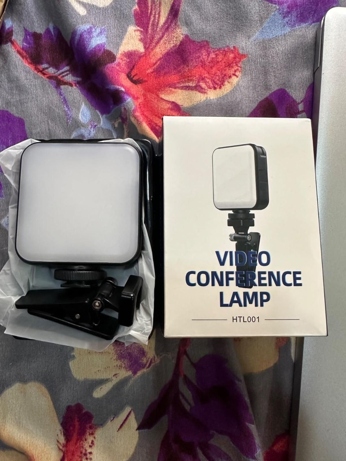 Video conference lamp with packaging on a floral-patterned surface