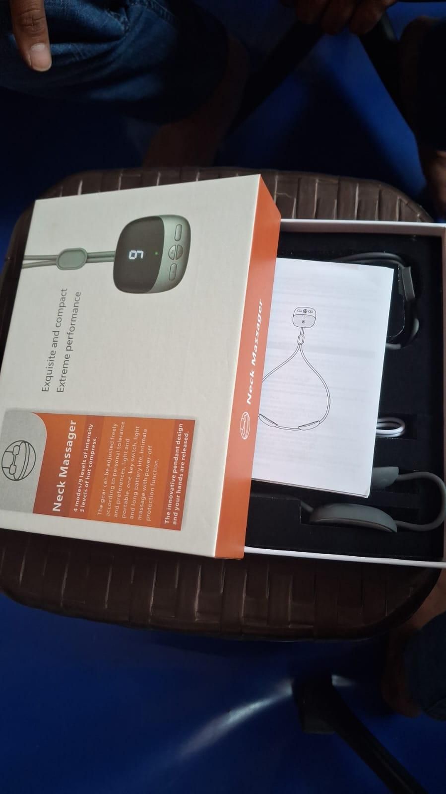 Smart Neck Massager packaging with manual and components