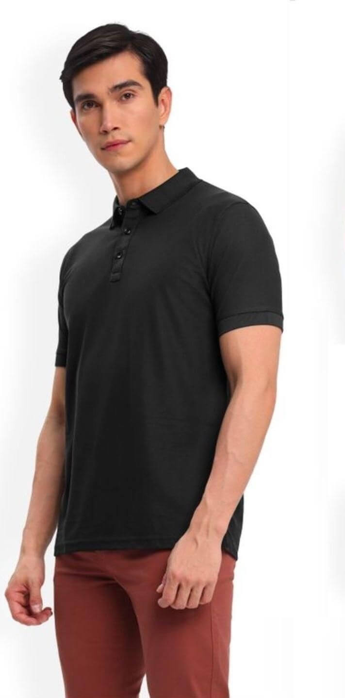 Man wearing a black polo shirt and red pants on a white background