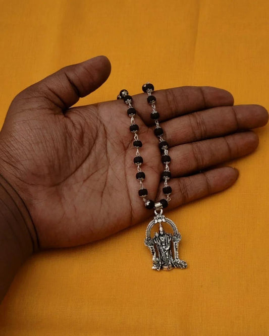 Karungali Mala with Murugan Locket displayed in hand, showcasing traditional black beads and spiritual design.