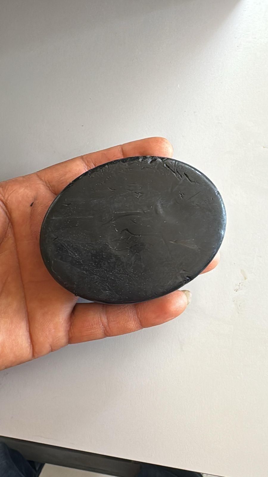 Polygonum Shampoo Bar held in hand showing actual product texture and size