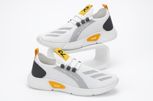 White athletic shoes with gray and black accents and orange accents on a white background